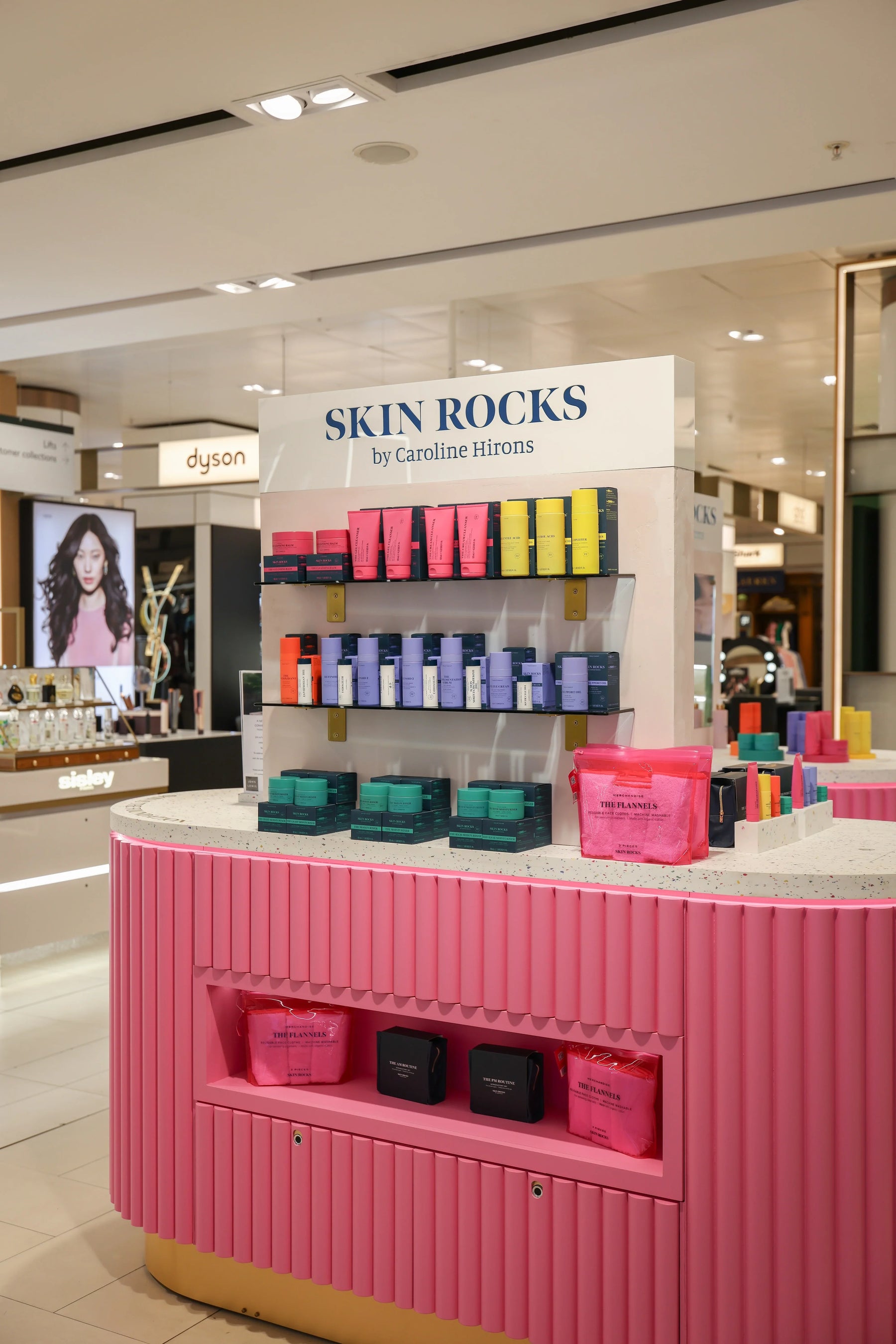 Skin Rocks by Caroline Hirons | Skincare display with colorful products on pink shelves in store