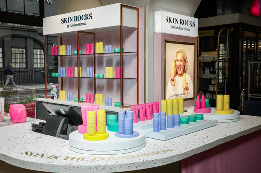 Skin Rocks by Caroline Hirons | Skincare display with colorful products, Caroline Hirons poster, and branded counter