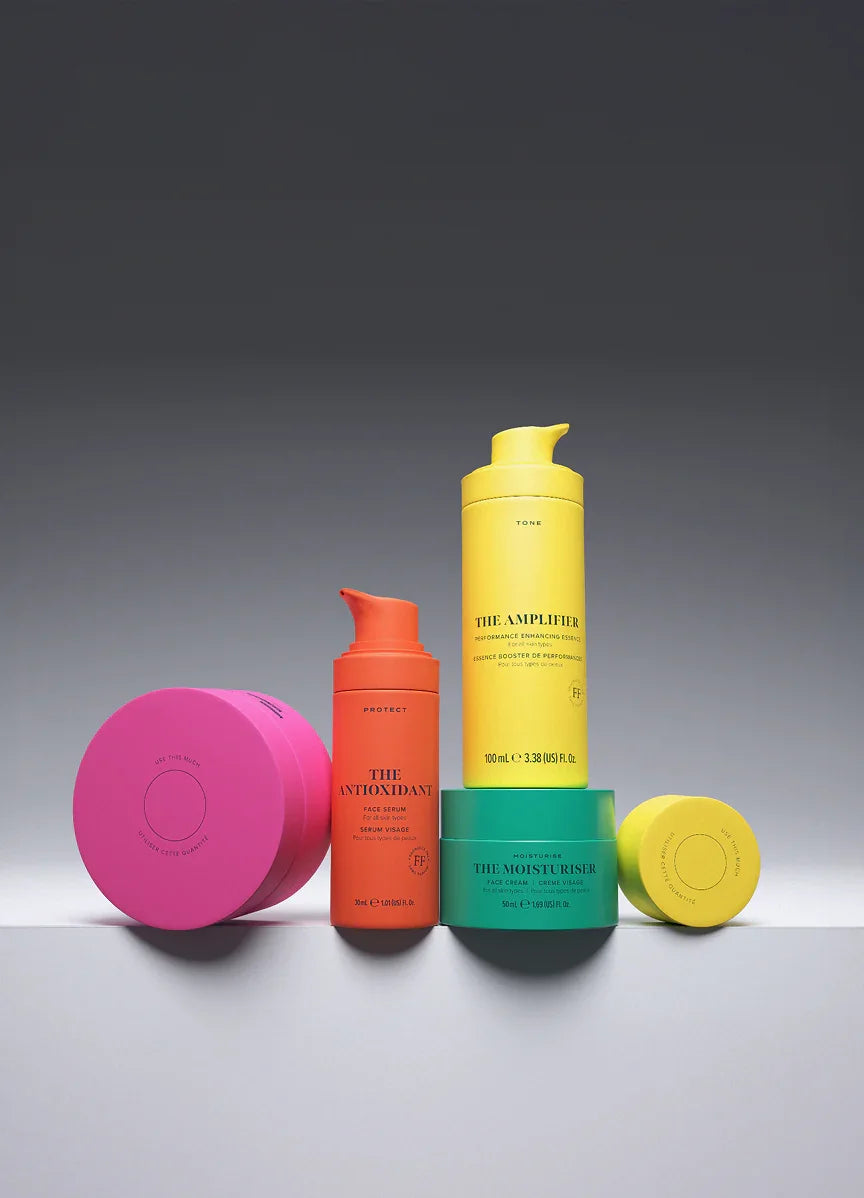 Skin Rocks by Caroline Hirons | The Antioxidant face serum, The Amplifier essence, The Moisturiser cream, and pink jar displayed on white surface