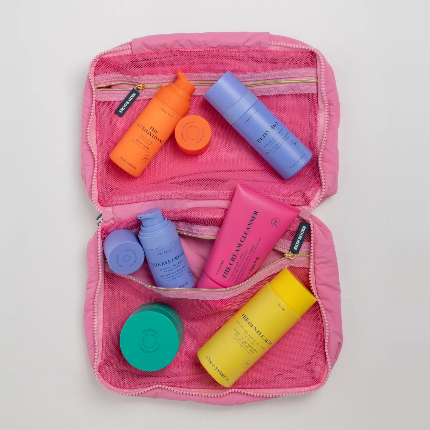 Skin Rocks by Caroline Hirons | Travel skincare set with antioxidant serum, retinoid, eye cream, cleanser & gentle acid in pink pouch