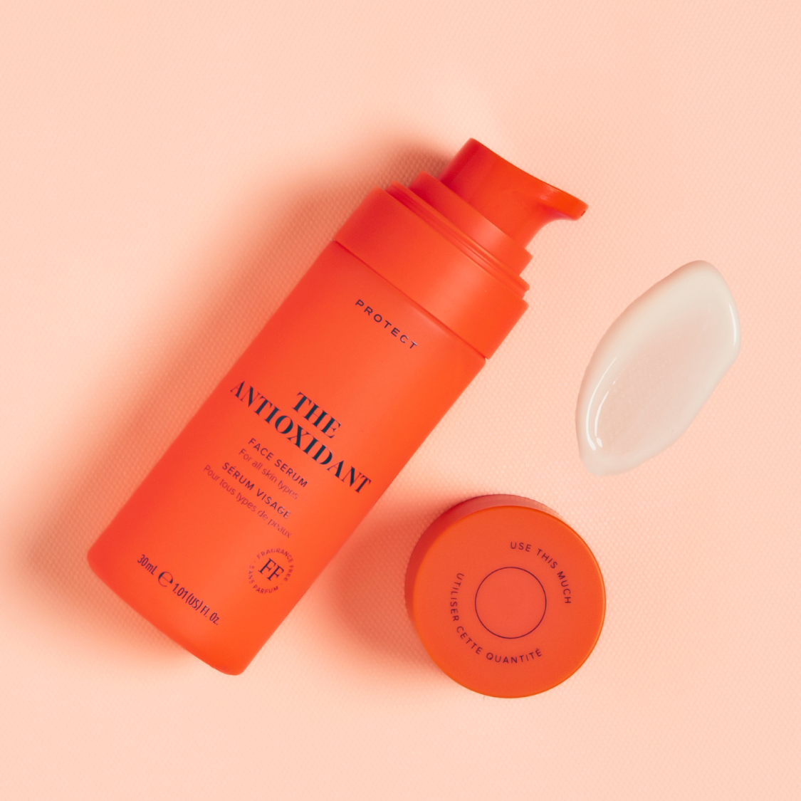 Skin Rocks by Caroline Hirons | The Antioxidant face serum bottle and swatch on a peach background